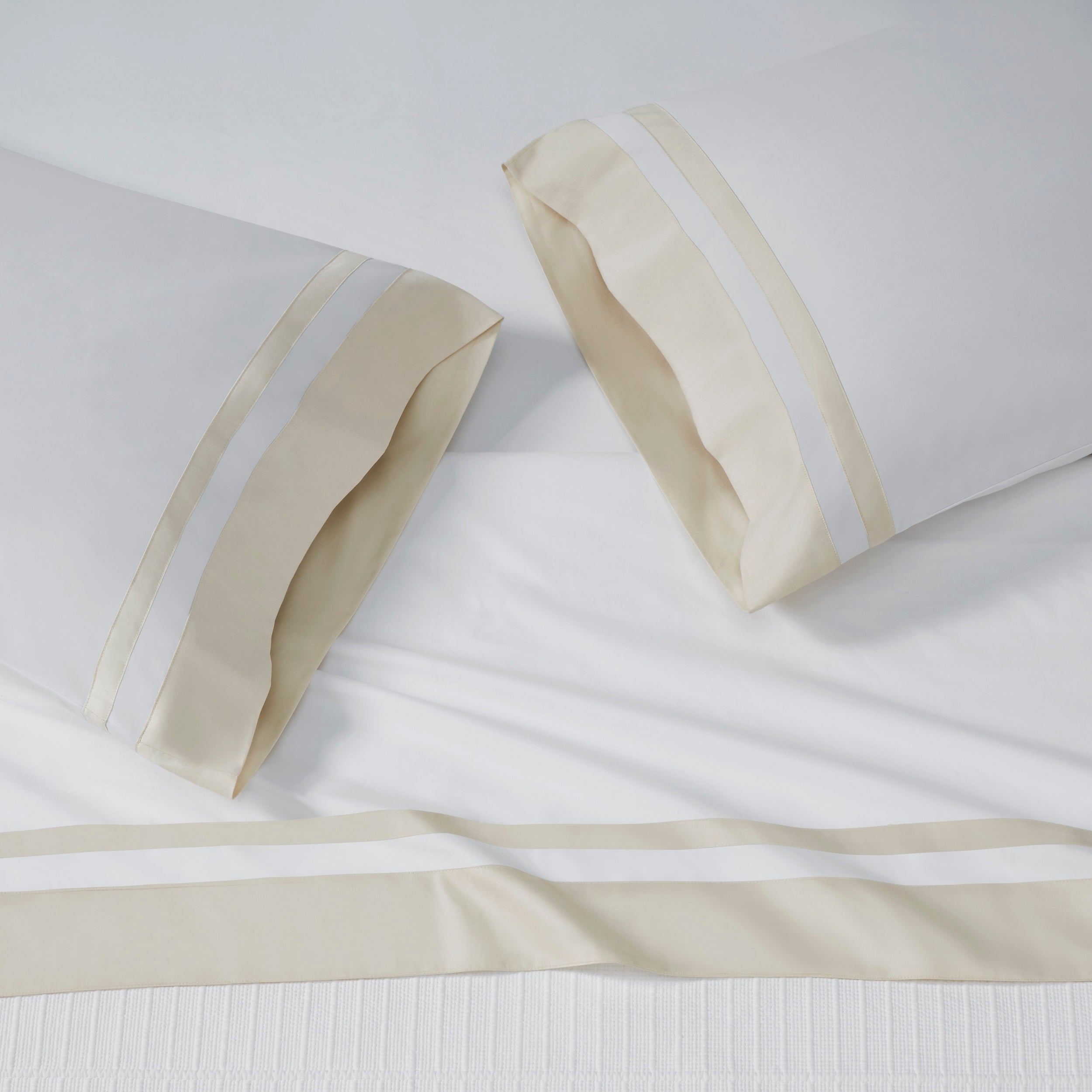 ASP-540-2032_2|White 100% cotton sateen flat sheet and two pillowcases, each featuring a wide beige border with dual white stripes.