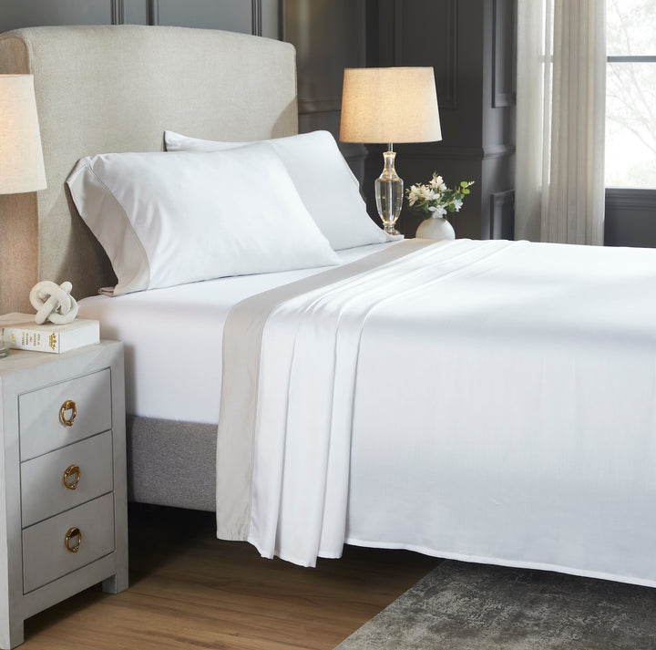 CSS-529-7284_2|Neatly made bed with crisp white 100% Lyocell sheet set & beige border, luxury breathable bedding comfort.