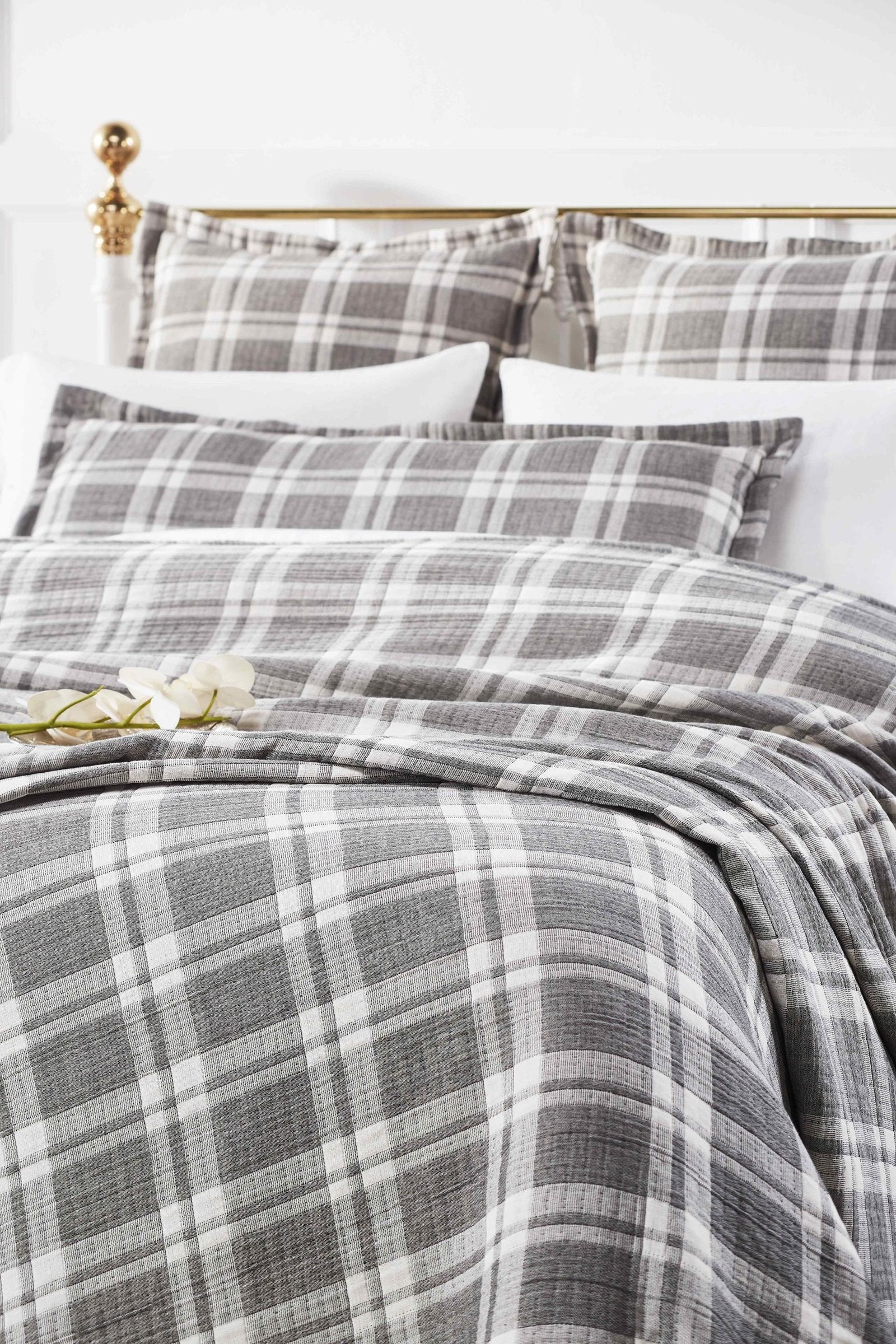 BT-116-11096_1|Cozy grey and white plaid blanket styled on a bed, adding a classic yet modern touch to bedroom decor.