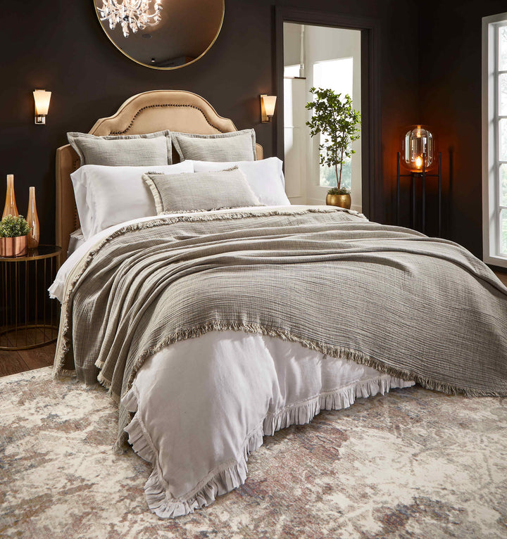BT-113-9496_1|Soft textured blanket with fringed edges on a bed, adding cozy warmth and stylish comfort to any bedroom decor.