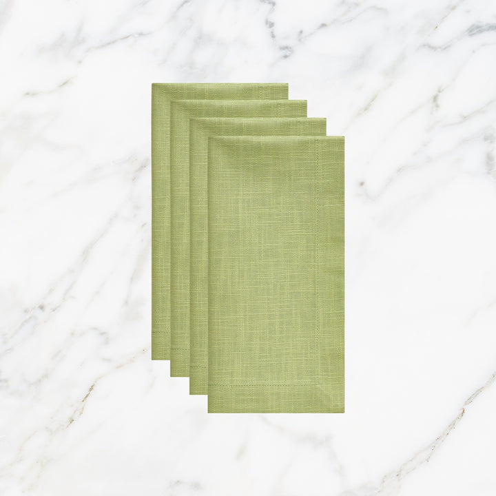 NP-4805-2020_1|Four folded lime green linen-look napkins, elegant table setting accessories on a white marble background. Durable fabric.