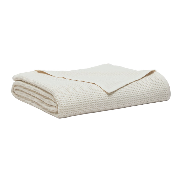 BL-867-11096_2|Folded cream waffle weave blanket. Soft, breathable cotton throw blanket for bed or sofa, adding texture and warmth to any room.