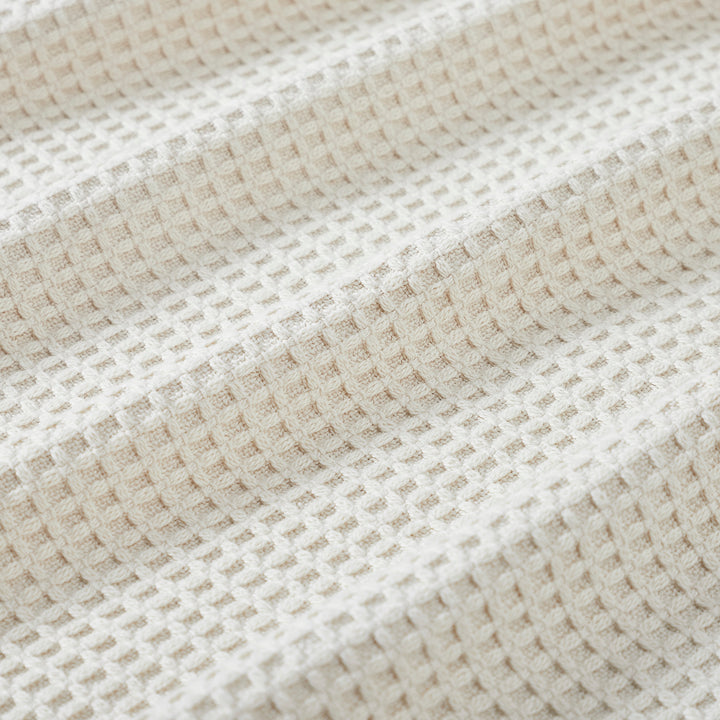 BL-867-11096_4|Close-up of a cozy cream waffle weave blanket texture. Soft, breathable cotton for ultimate comfort and home decor accent.