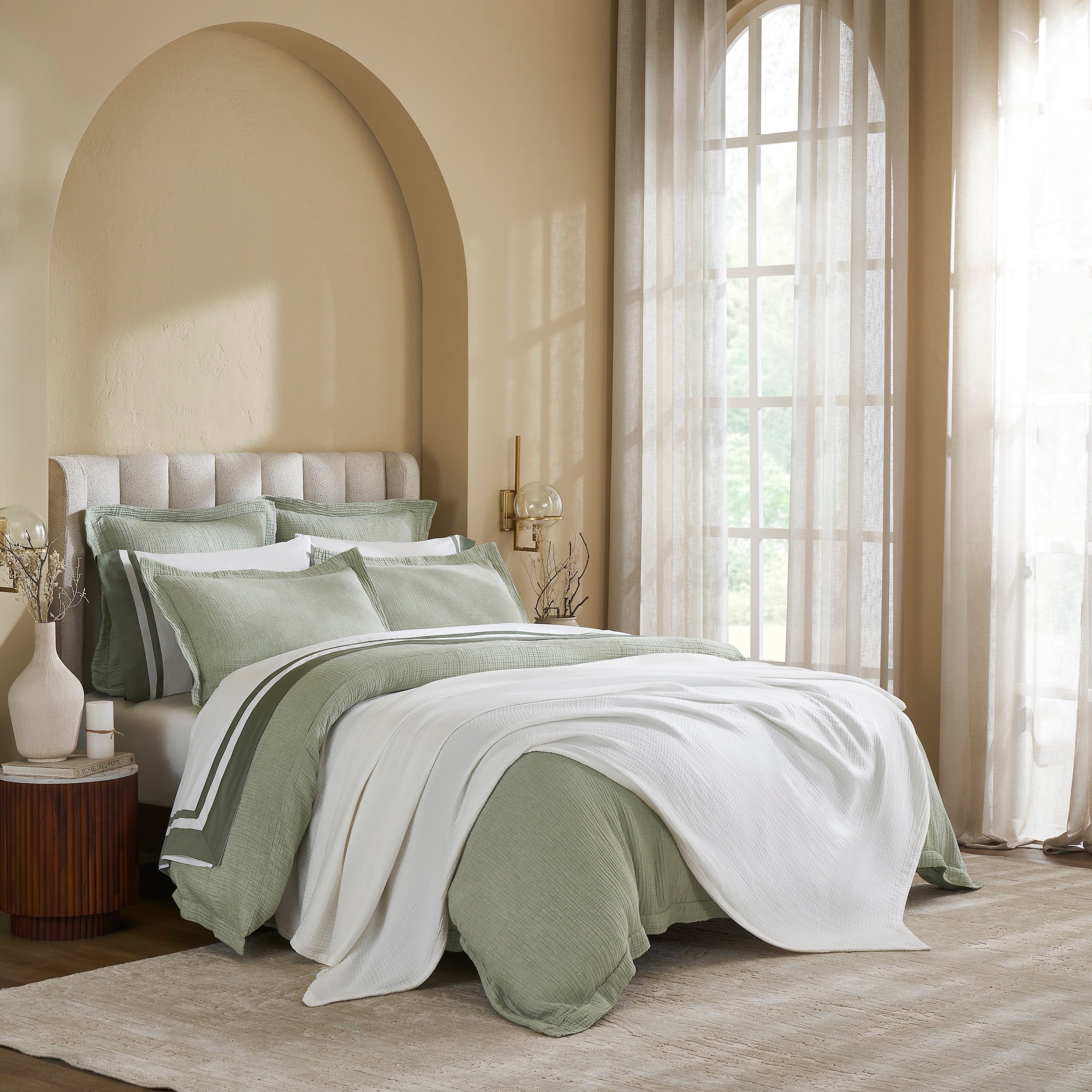 BL-861-9496_3|Soft white textured cotton blanket gracefully draped over a green duvet, enhancing the cozy and stylish modern bedroom decor.