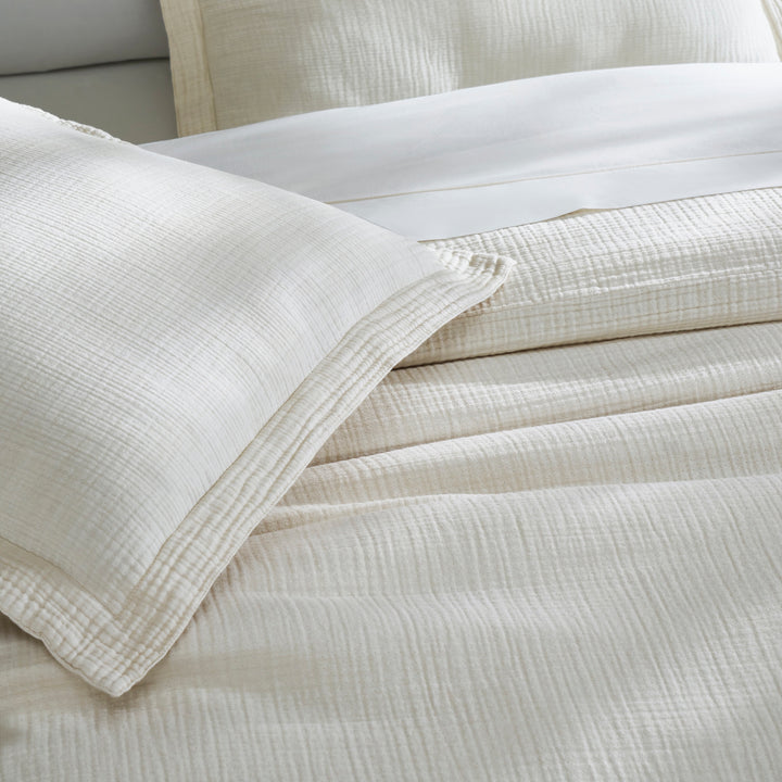 SS-049-2026_3|Elegant natural beige organic cotton duvet cover and matching pillow shams on a bed, creating a serene atmosphere.