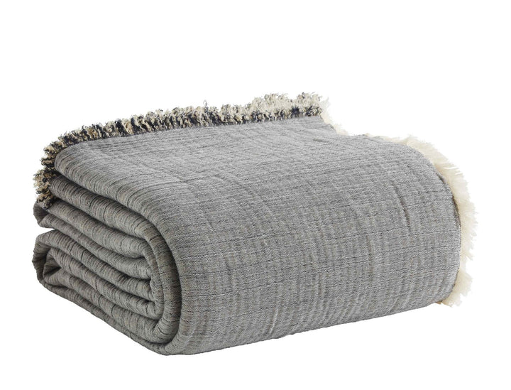 BT-104-9496_3|Soft gray fringed blanket, neatly folded, offering reversible design. Ideal for adding a touch of cozy texture to any living space.