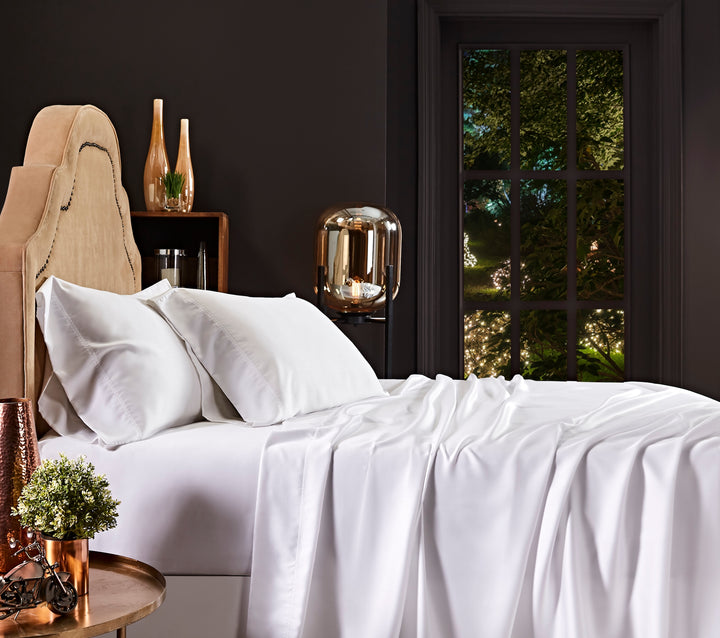 KFL-509-7880_2|White 100% Lyocell sheet set on a bed, including a fitted sheet, a casually draped flat sheet, and two pillowcases.