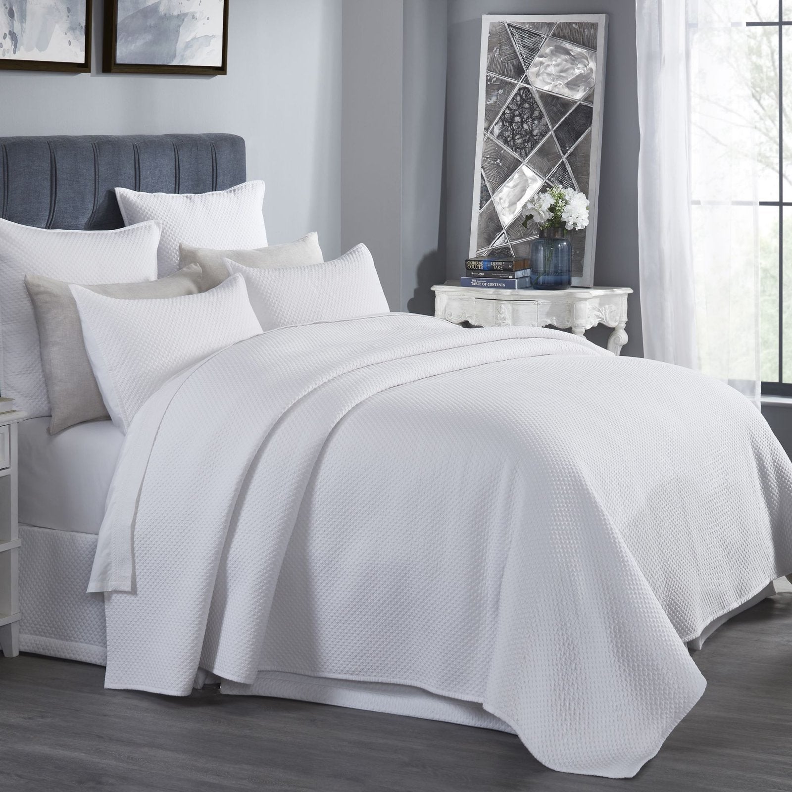 CL-200-11096_2|Luxurious white textured coverlet draped beautifully on a bed, creating a comfortable and contemporary bedroom look.