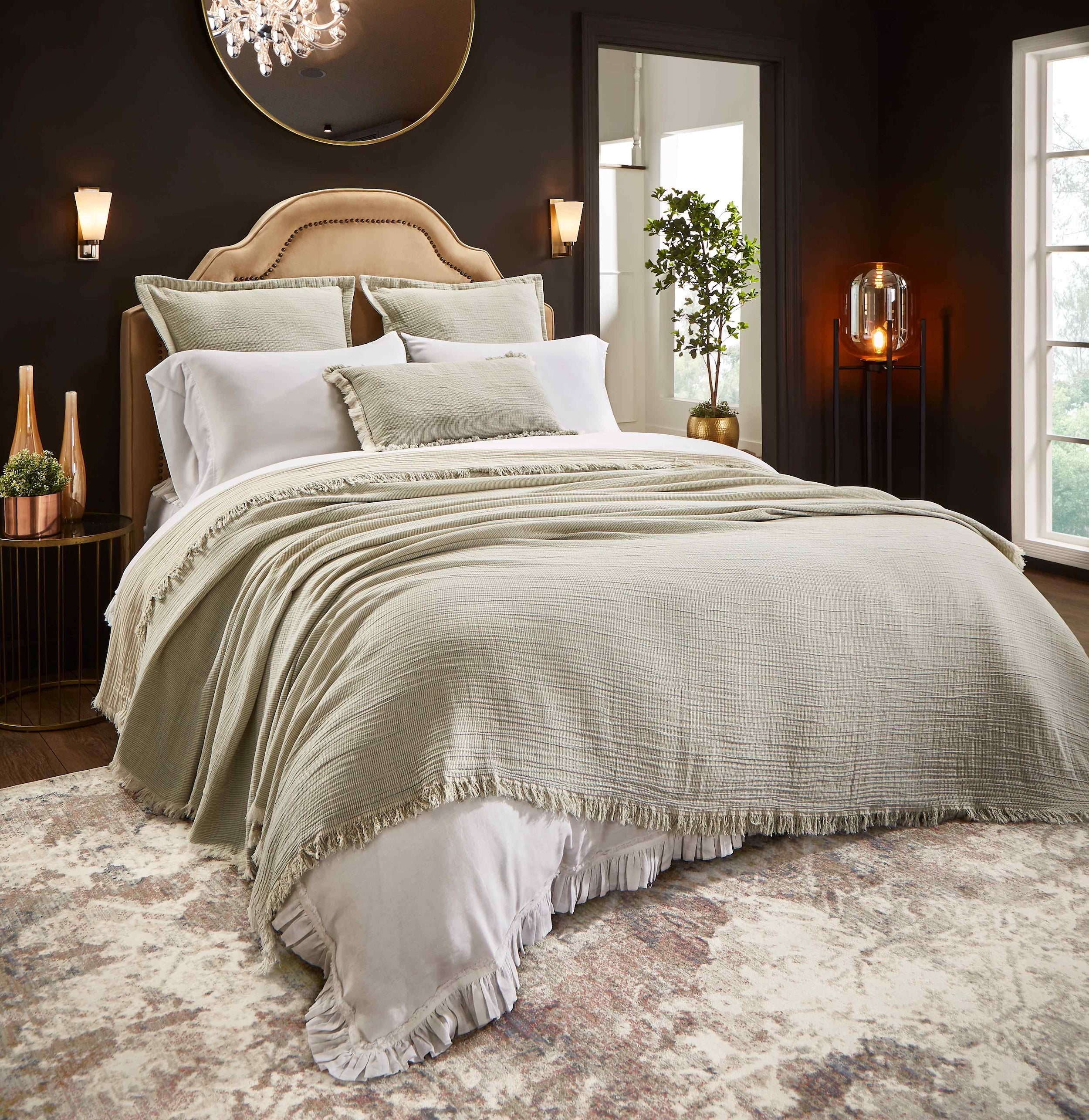 BT-111-9496_1|Elegant, textured sage green blanket with fringe detail covers a luxurious bed, enhancing bedroom comfort and style.