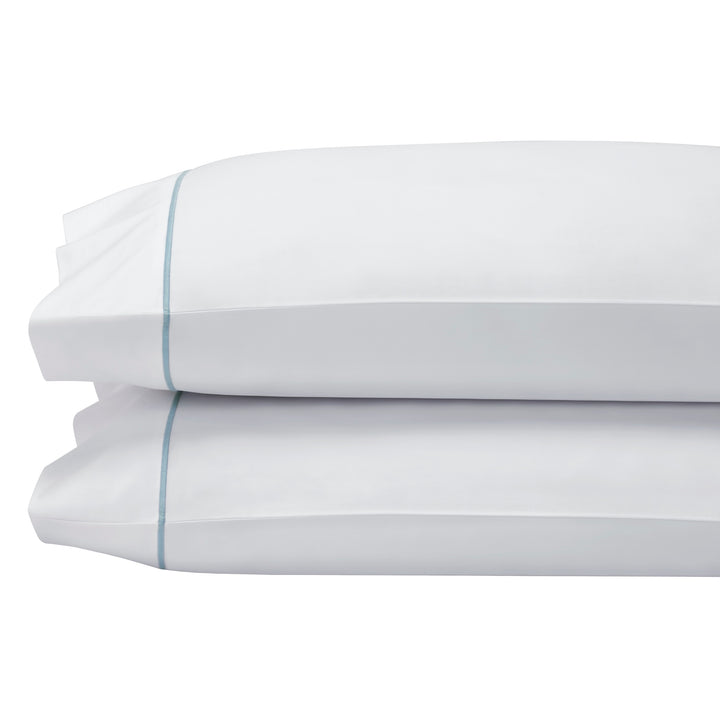 ASP-530-2032_2|Stack of two luxurious 100% cotton sheets: pure white pillow shams with elegant aqua blue piping. Premium comfort.
