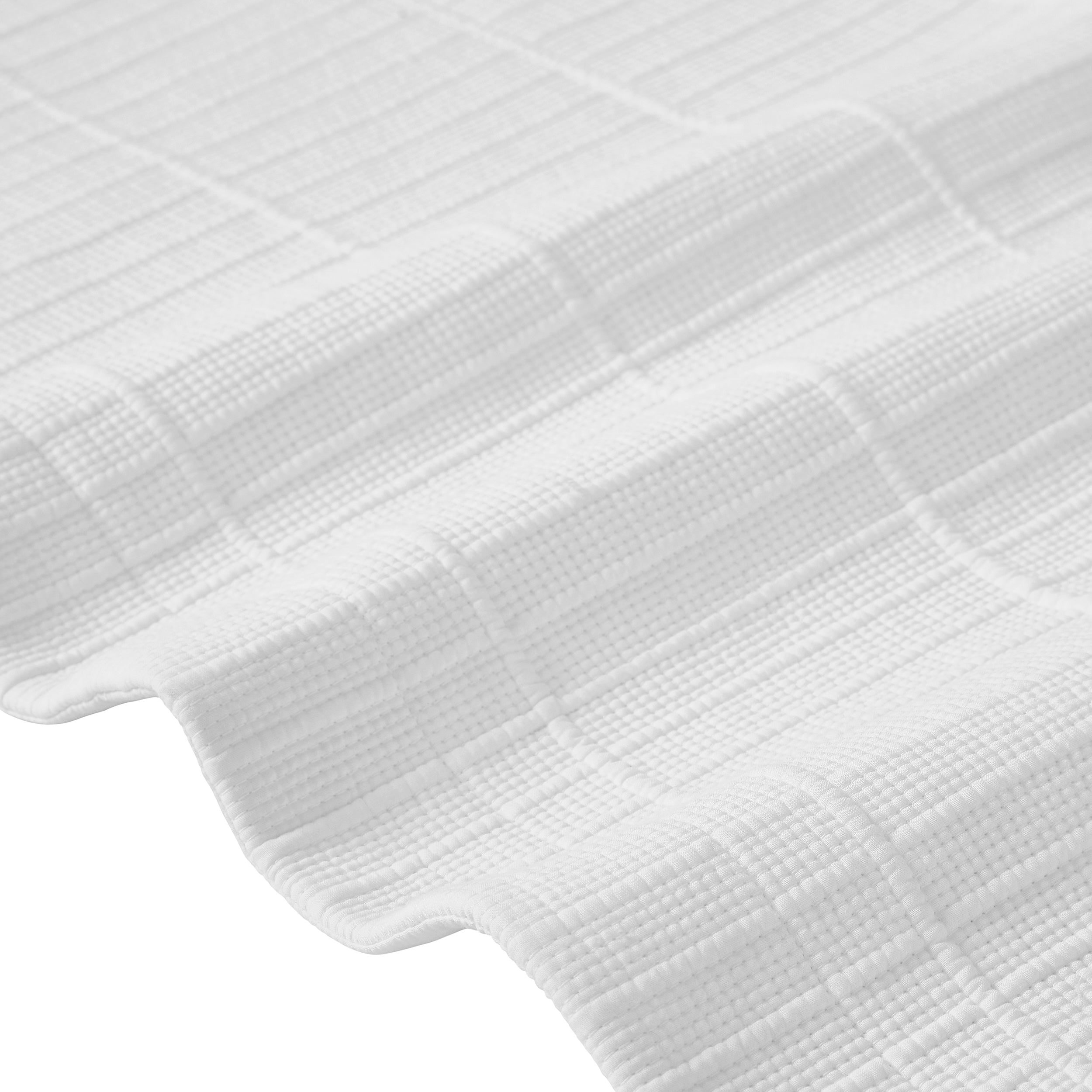 CL-268-9496_9|Detailed close-up of a luxurious white textured coverlet fabric, showcasing its intricate woven pattern for elegant bedding comfort.