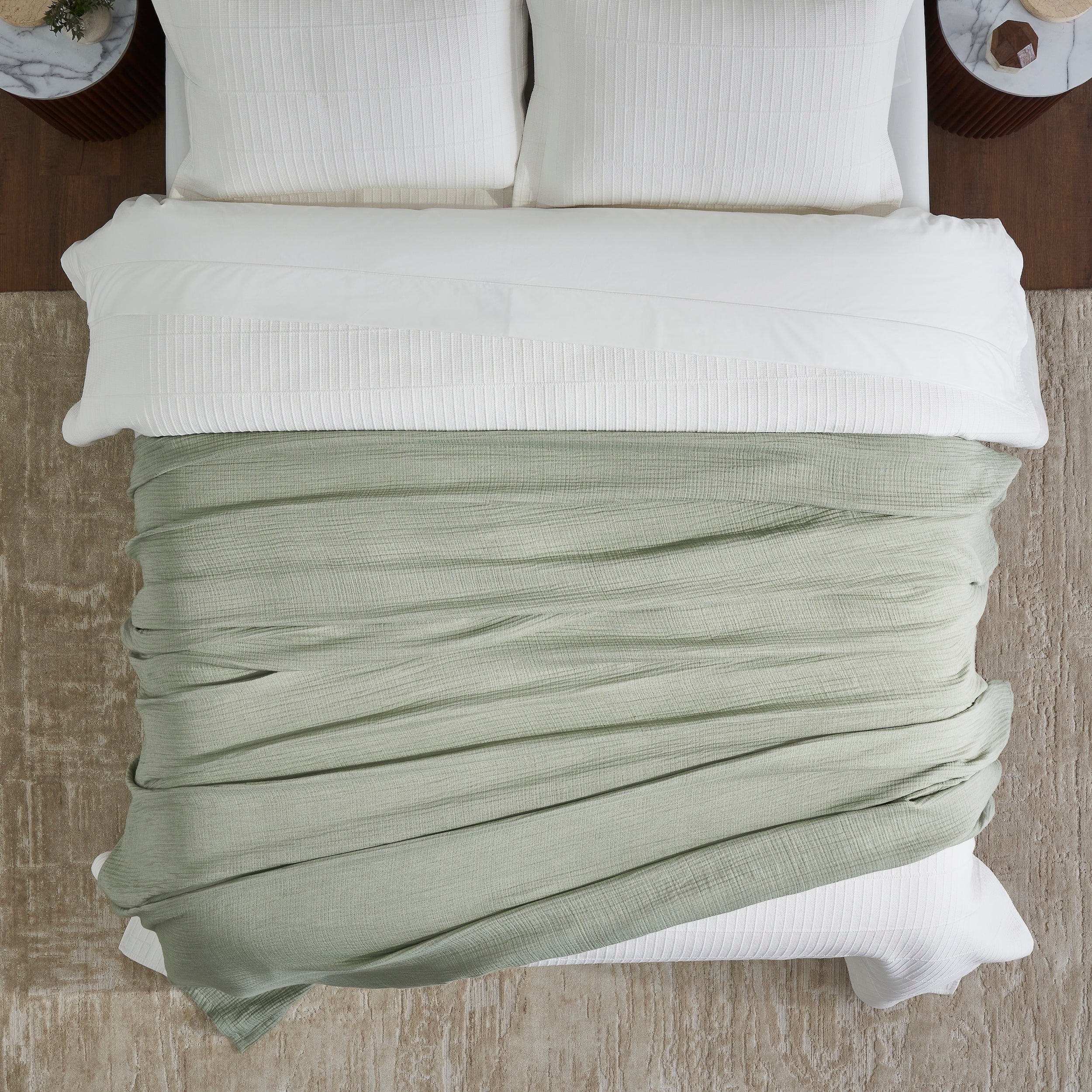 BL-864-9496_4|Soft sage green textured blanket draped elegantly over a crisp white bed, enhancing bedroom decor with cozy, natural charm.