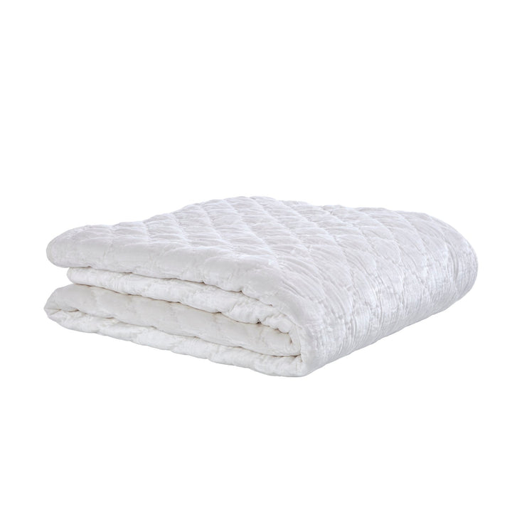 QT-343-9496_3|Folded white velvet quilt showcasing intricate diamond quilting. Luxuriously soft and plush, perfect for crisp bedroom comfort.