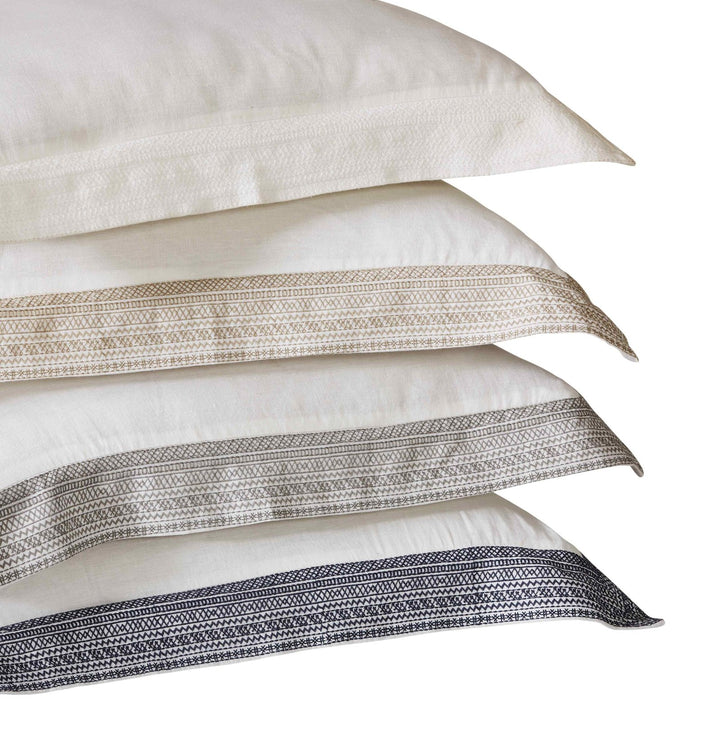SS-015-X_2|Stack of elegant pillow shams featuring geometric embroidered borders, part of a sophisticated duvet cover collection.