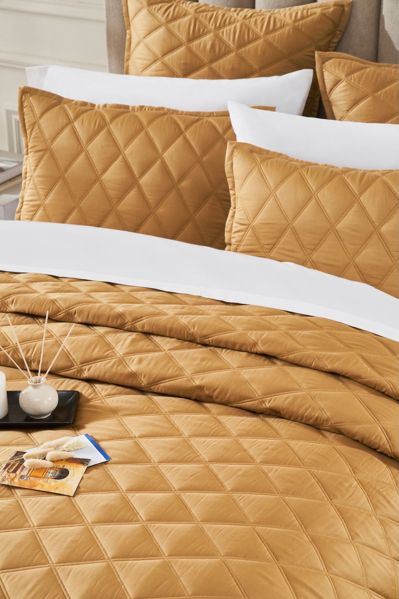 CL-260-9496_4|Close-up of a golden bronze quilted coverlet with soft diamond pattern, providing a luxurious and stylish bedroom foundation.