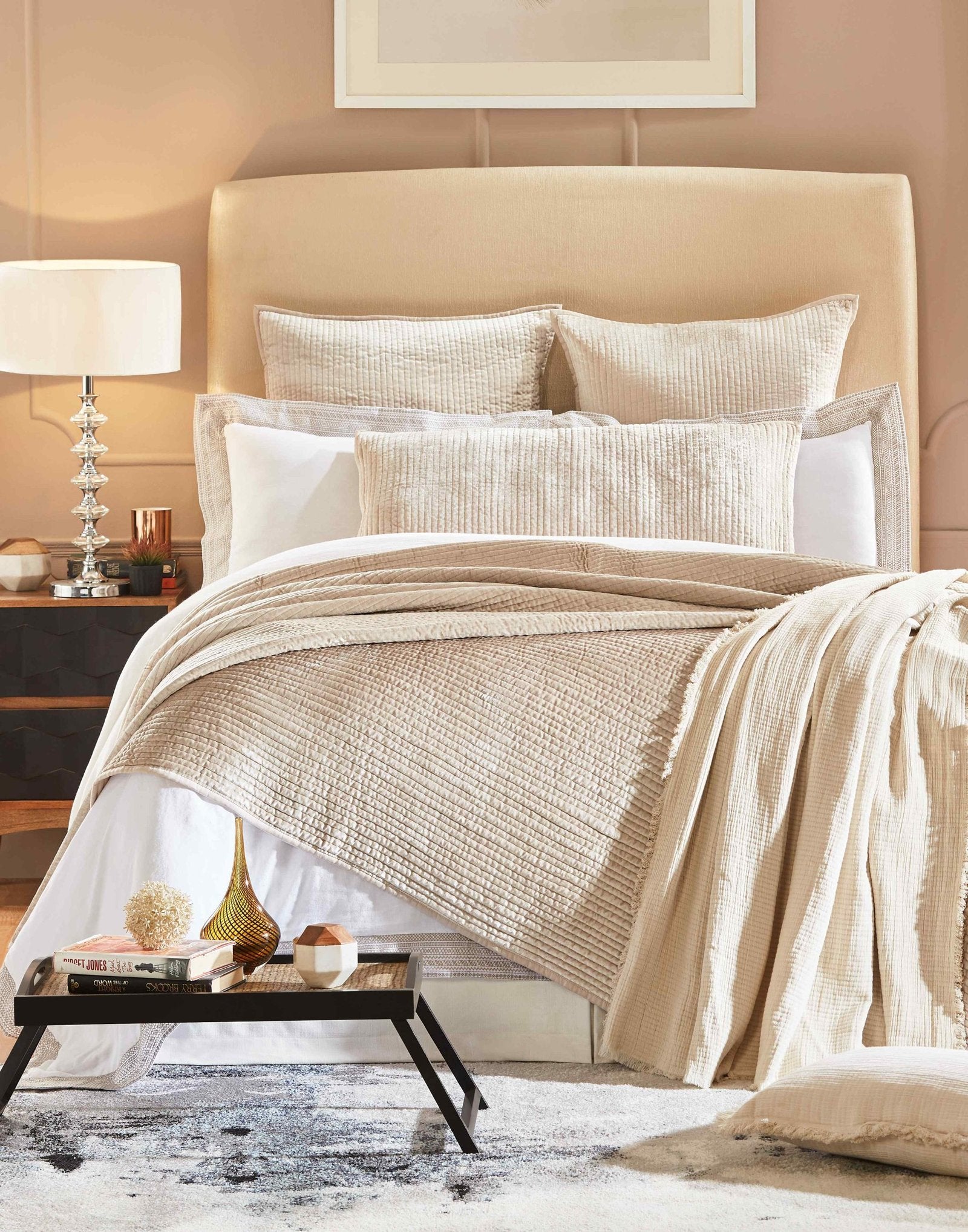 CL-154-9496_1|Luxurious beige quilted coverlet with a subtle texture, draping elegantly over a contemporary bed in a neutral-toned room.