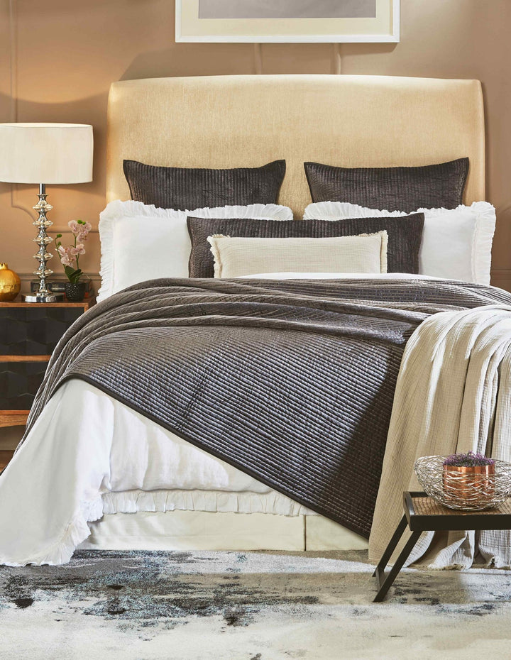 CL-153-9496_1|Luxurious dark grey quilted coverlet draped on a bed, adding elegant texture and warmth to modern bedroom decor.