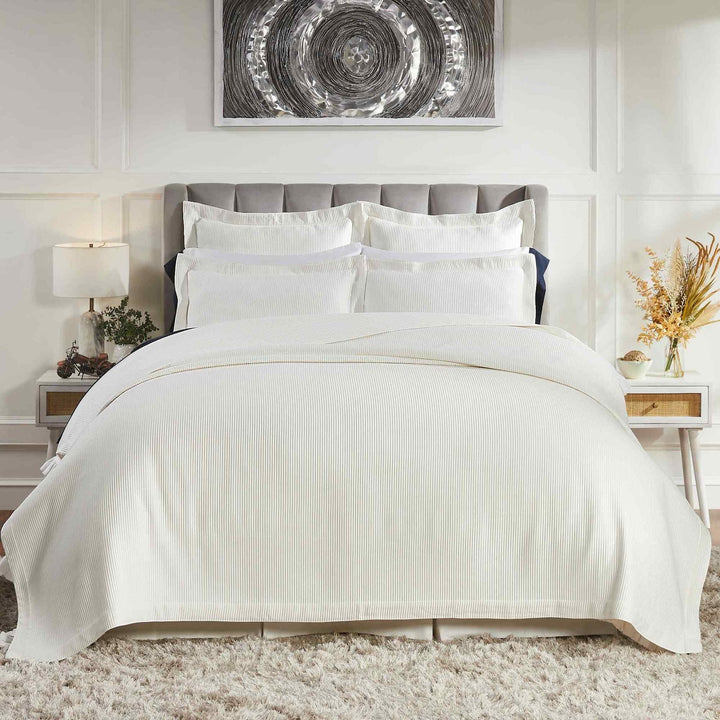 CL-192-9496_1|Modern white striped coverlet on a luxurious bed, providing a cozy and stylish foundation for any bedroom decor.