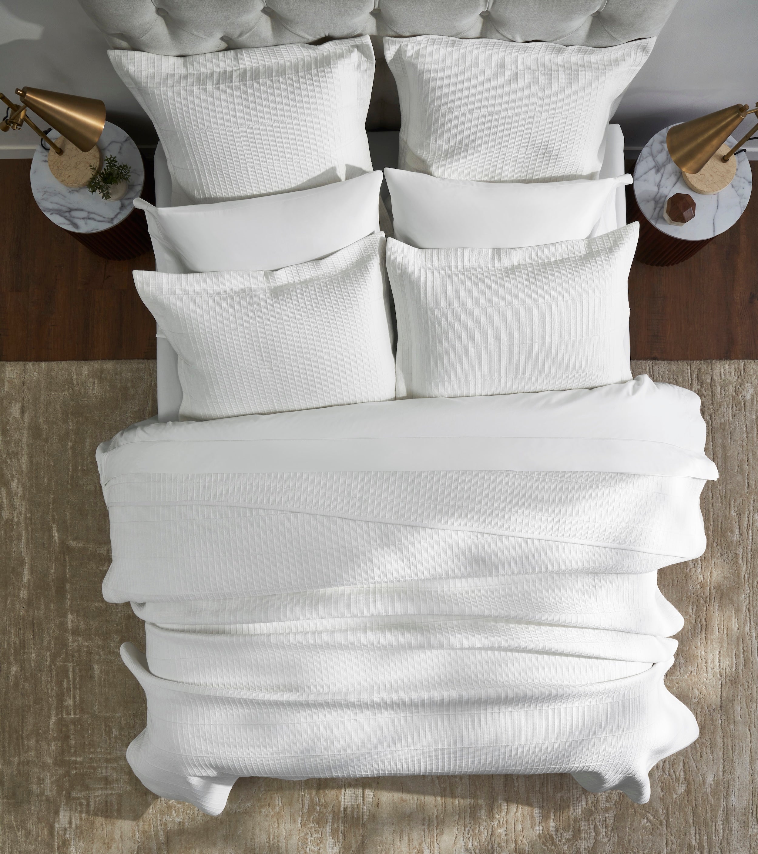 CL-268-9496_3|Pristine white textured coverlet with a subtle striped pattern, neatly arranged on a modern bed for a cozy aesthetic.