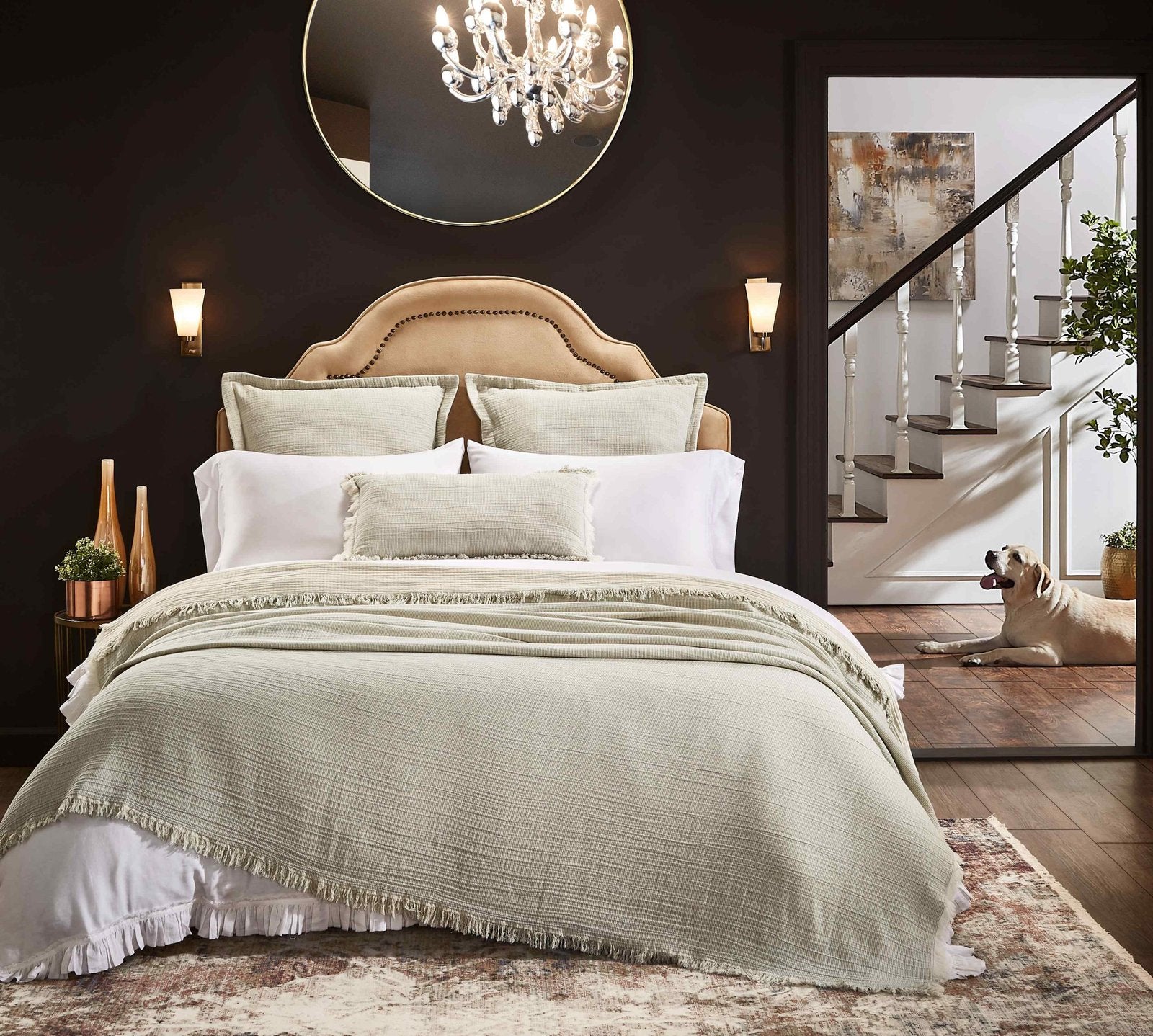 BT-111-11096_5|Cozy sage green textured cotton throw blanket with fringe draped over a plush bed. Perfect for adding comfort & style.