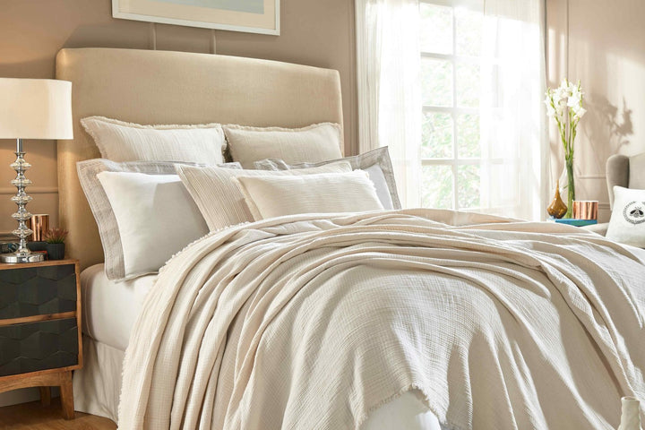 BT-103-X_1|Cozy cream crinkled throw blanket draped over a bed with matching shams. Adds soft texture and comfort to any room.