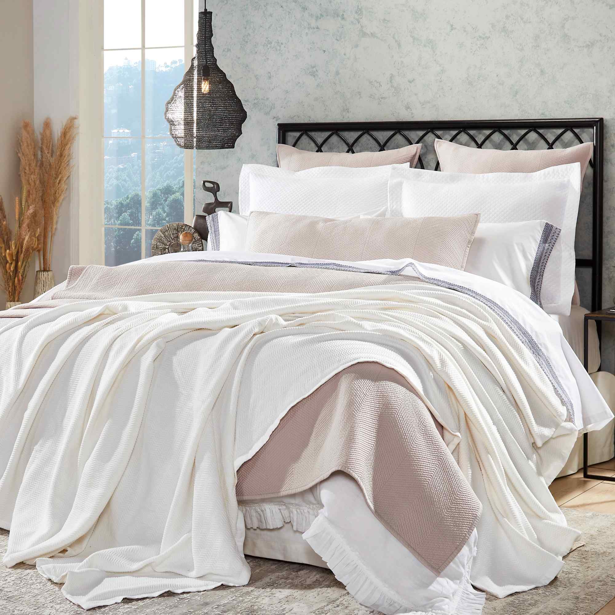 BL-854-9496_1|Beautifully layered white herringbone blanket and light pink throw on a luxurious bed setting, enhancing bedroom style.