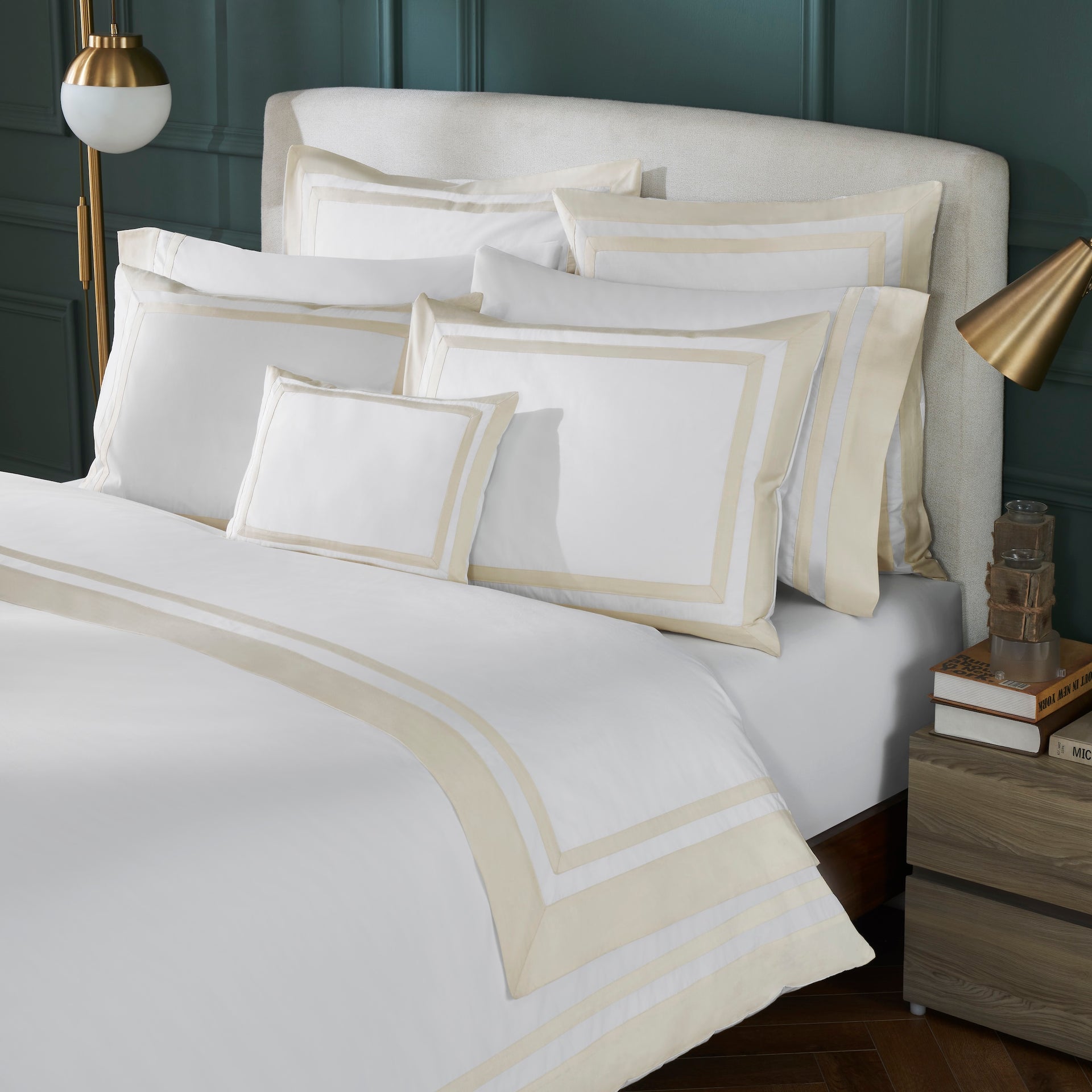 DT-069-X_1|Luxurious white duvet cover with elegant light beige borders and multiple pillow shams on a classic bedroom setting.