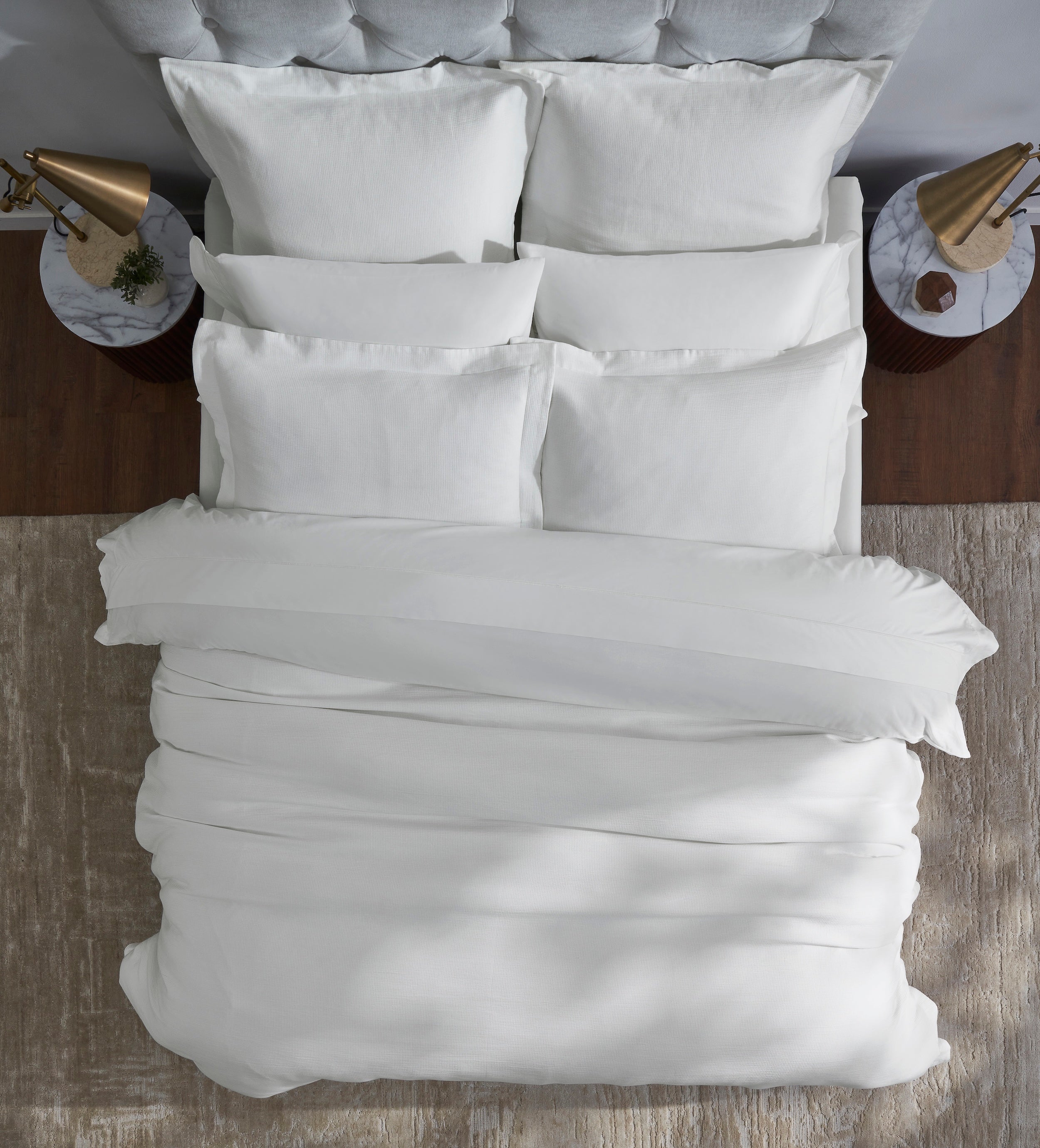 DT-067-9092_5|Crisp white textured duvet cover neatly arranged on a modern bed, viewed from above, showcasing clean lines and comfort.