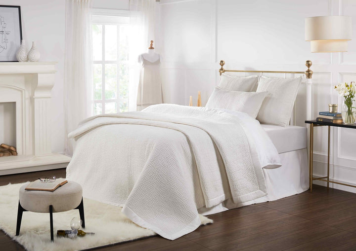 CL-165-11096_5|Crisp white textured coverlet on a classic bed in a bright, airy bedroom, providing sophisticated and inviting bedding.