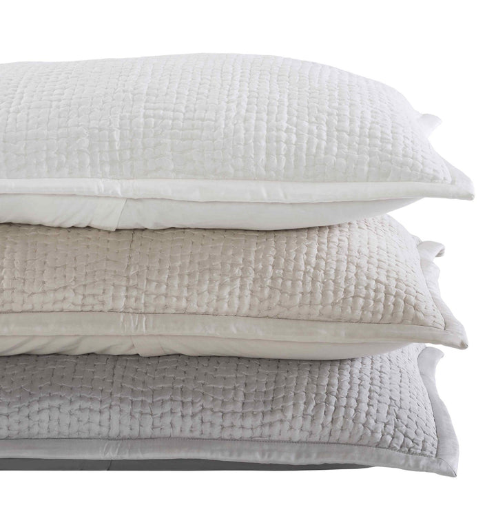 SS-165-X_1|Stack of three textured coverlets in off-white, beige, and grey with a small, uniform waffle-like quilting pattern.