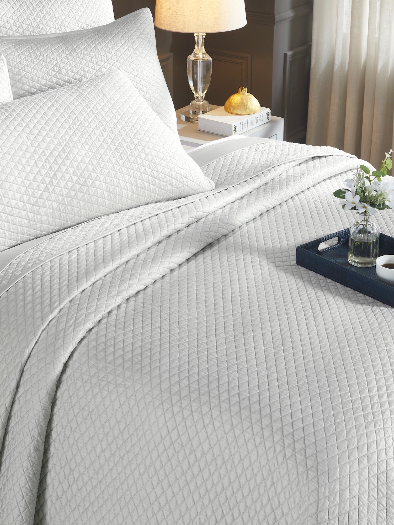 CL-266-9496_4|Cozy white diamond quilted coverlet creating a sophisticated look on a bed, perfect for a serene and luxurious bedroom.