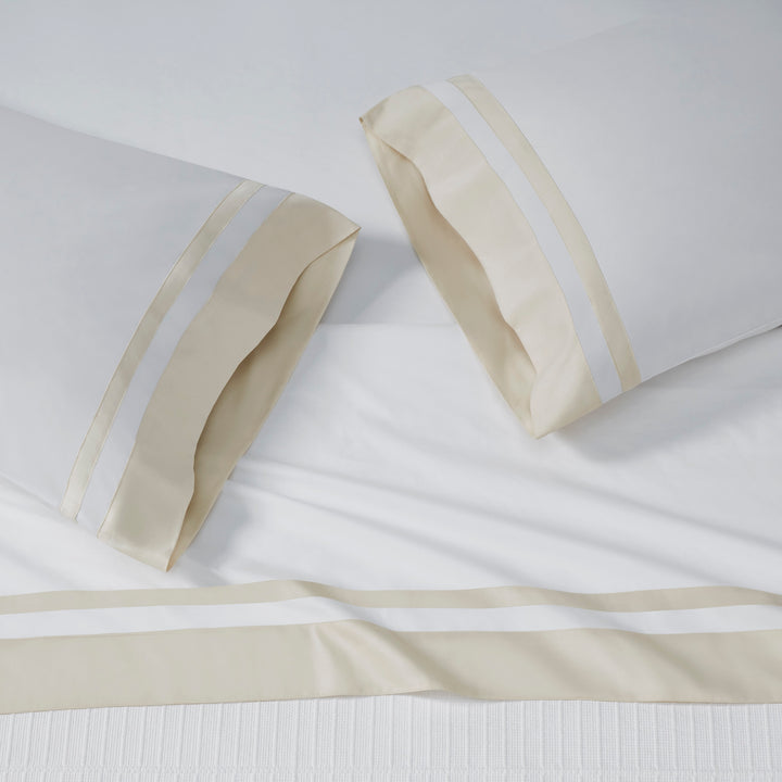 AKP-540-2040_2|White 100% cotton sateen sheet set, including two pillowcases and a flat sheet, each with wide beige and white striped borders.