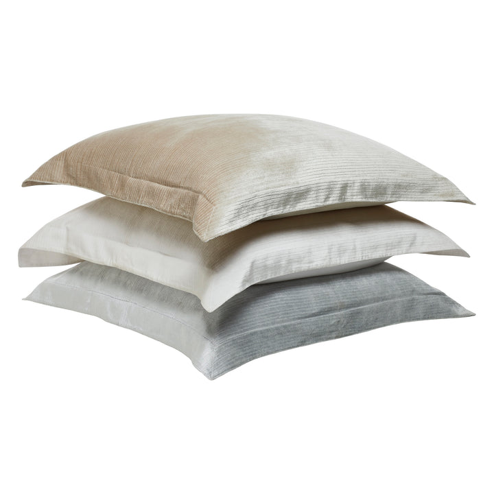 ES-054-2626_5|Stacked assorted duvet cover collection pillows, featuring beige, white, and grey textured velvet shams for versatile decor.