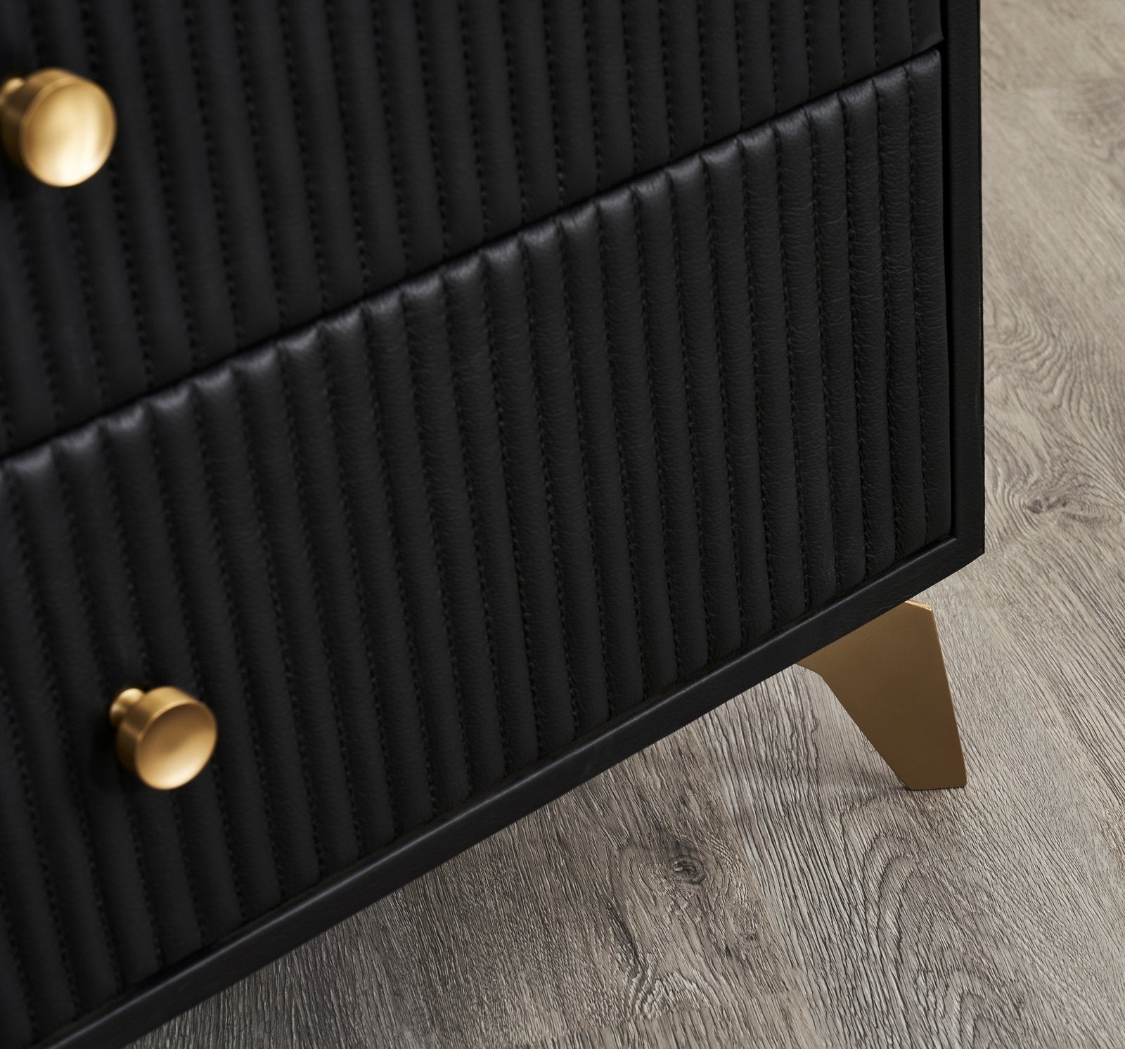 FN-5202-642033_8|Close-up showcasing the elegant gold feet and textured black side panel of a stylish, modern bedroom dresser.