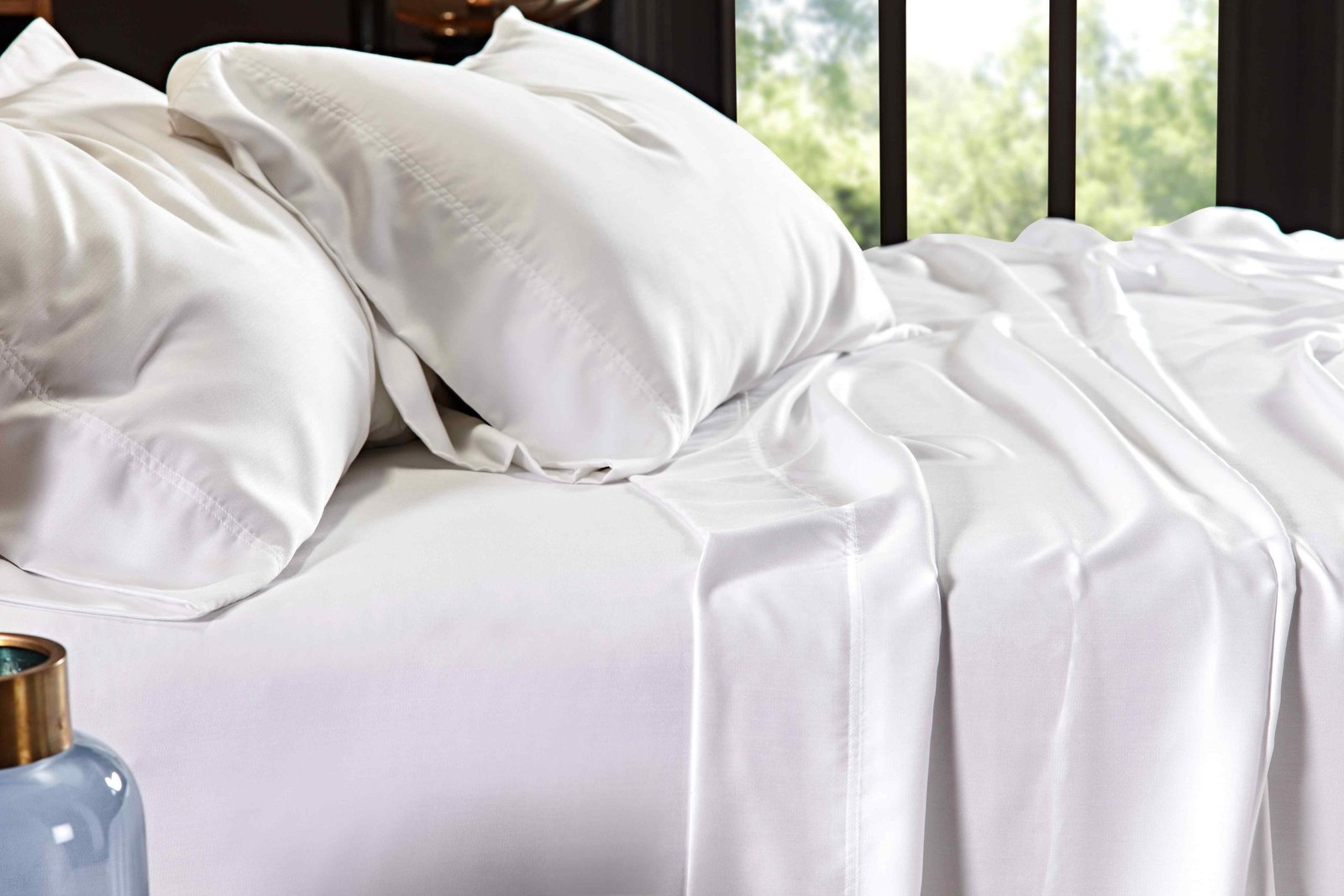 QFT-509-6080_3|Luxurious white 100% Lyocell sheets draped over a bed, with smooth, breathable fabric, perfect for a comfortable night's sleep.