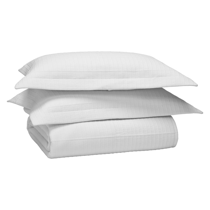 CL-268-11096_10|Complete white textured coverlet bedding set, featuring a neatly folded quilt and two matching pillow shams for comfort.
