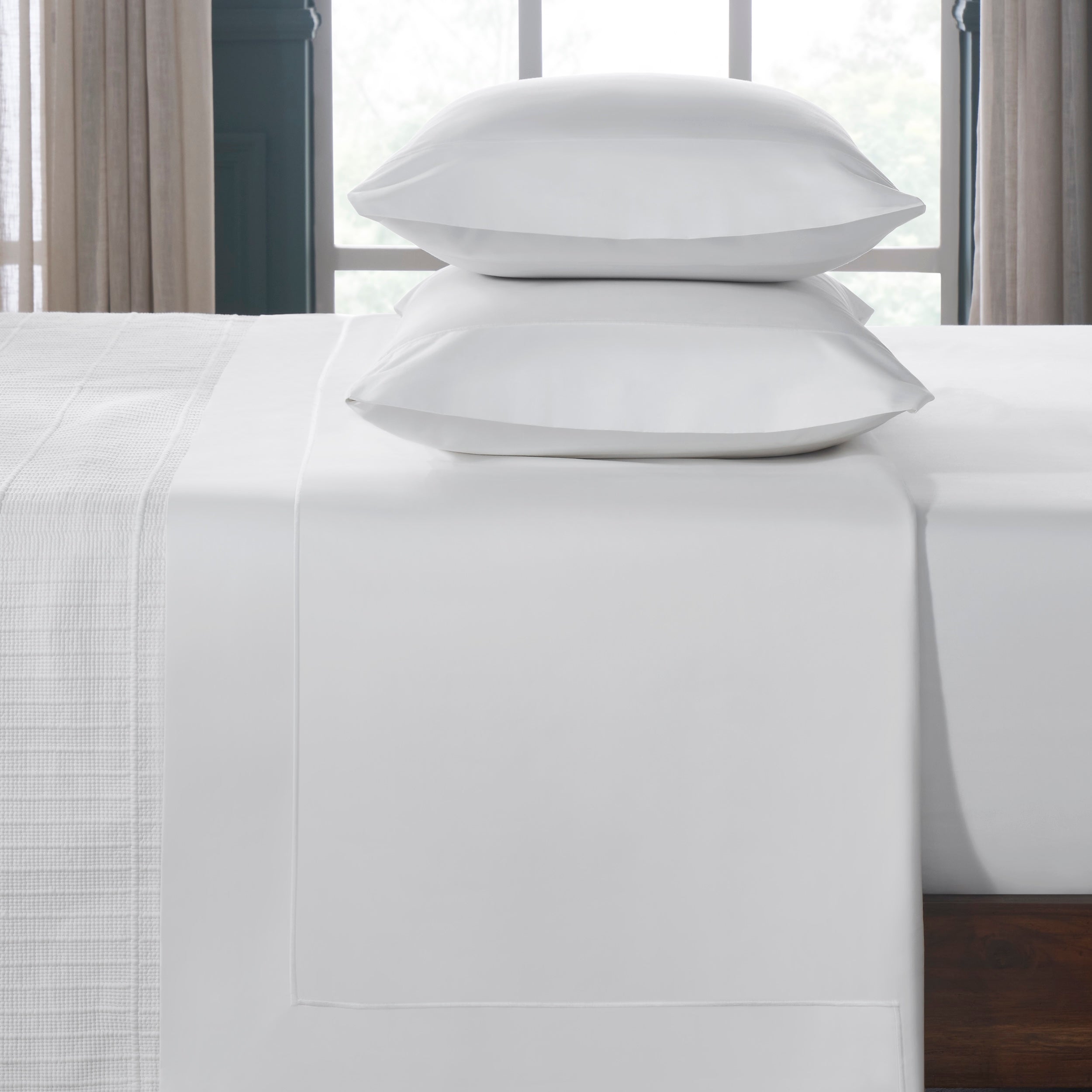 TFL-533-3980_3|Premium 100% cotton white sheets and pillowcases, folded neatly, offering pure crispness and comfort for beds.