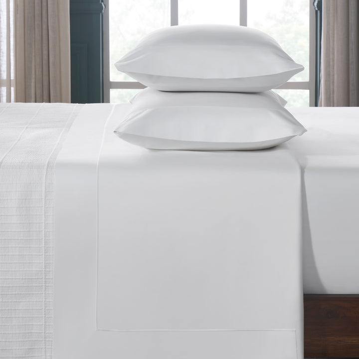 TFL-533-3980_3|Premium 100% cotton white sheets and pillowcases, folded neatly, offering pure crispness and comfort for beds.
