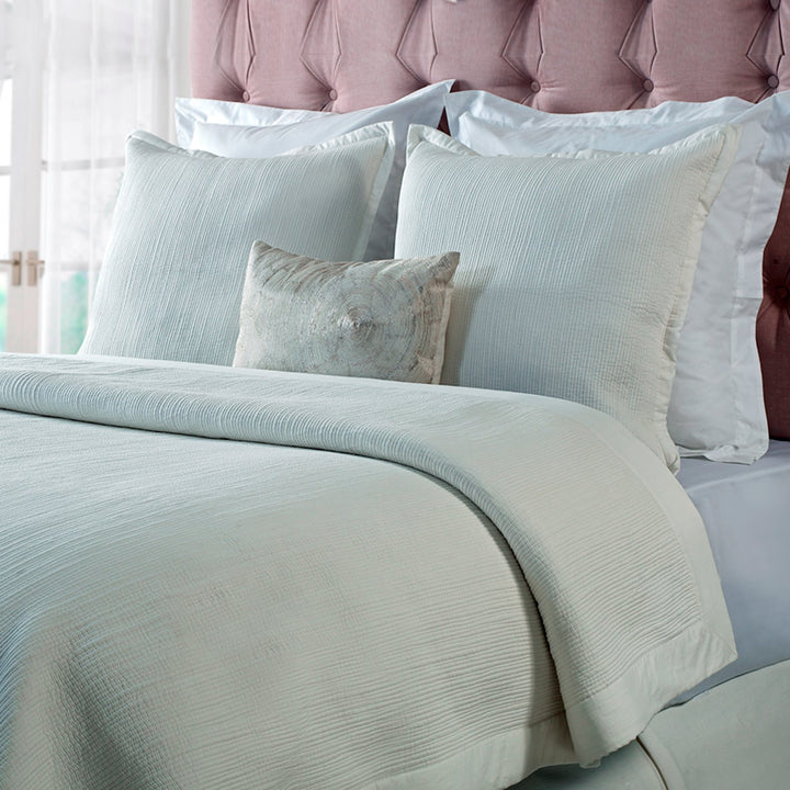 CL-158-7092_1|Elegant light cream textured coverlet providing a sophisticated and cozy layer on a bed, perfect for modern comfort.