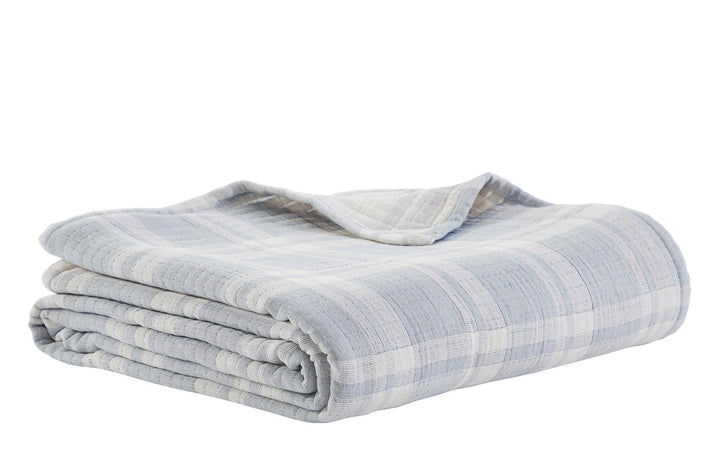 BT-117-9496_3|Neatly folded light blue and white plaid textured cotton blanket, ready for storage or cozy use on a cool evening.