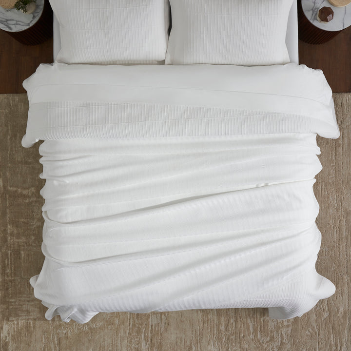 BL-865-9496_4|Overhead view of a modern bed featuring a crisp white ribbed blanket, offering warmth, comfort, and sophisticated bedroom decor.