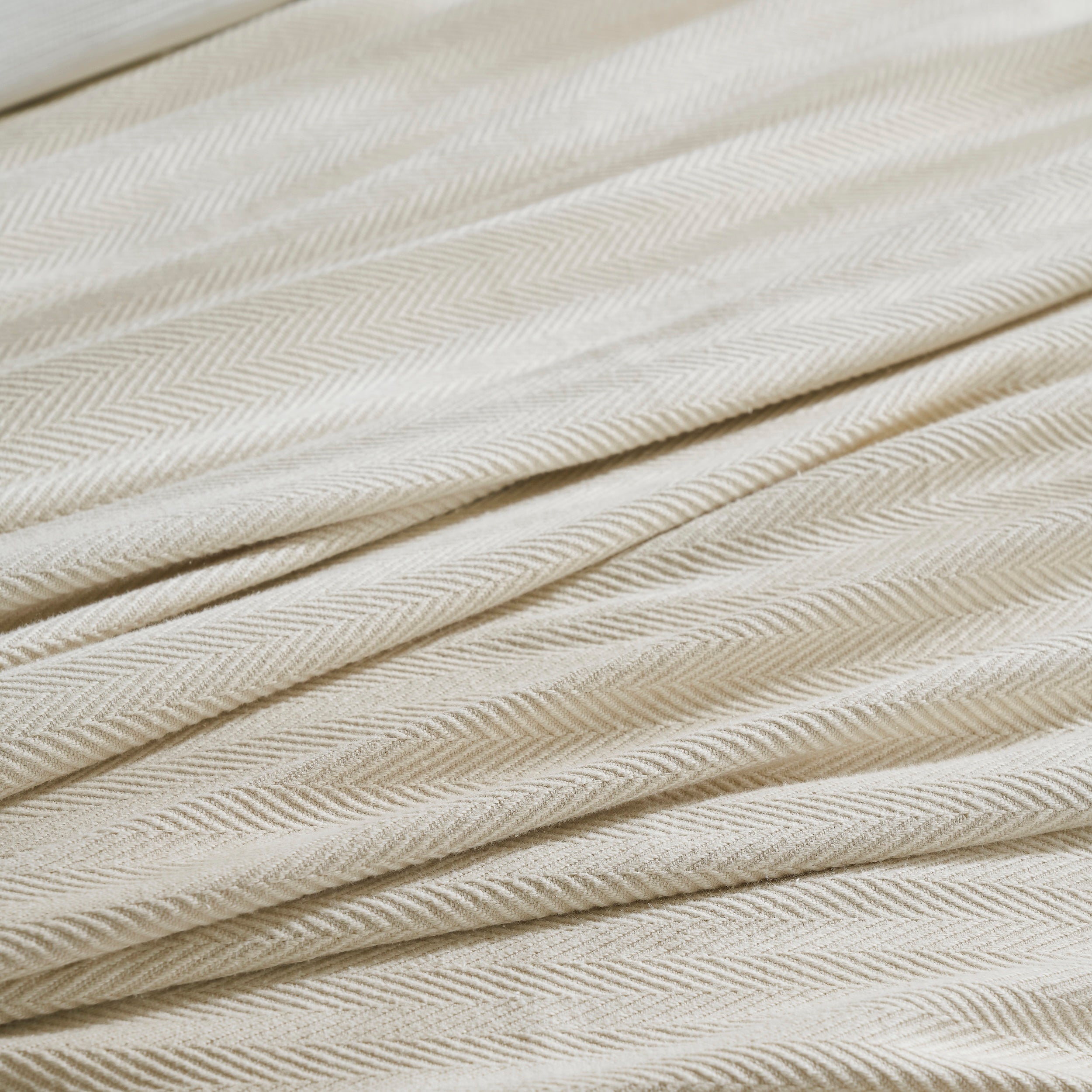 BL-866-9496_5|Detailed close-up of a luxurious light beige herringbone patterned blanket, showcasing its soft, intricate woven texture.