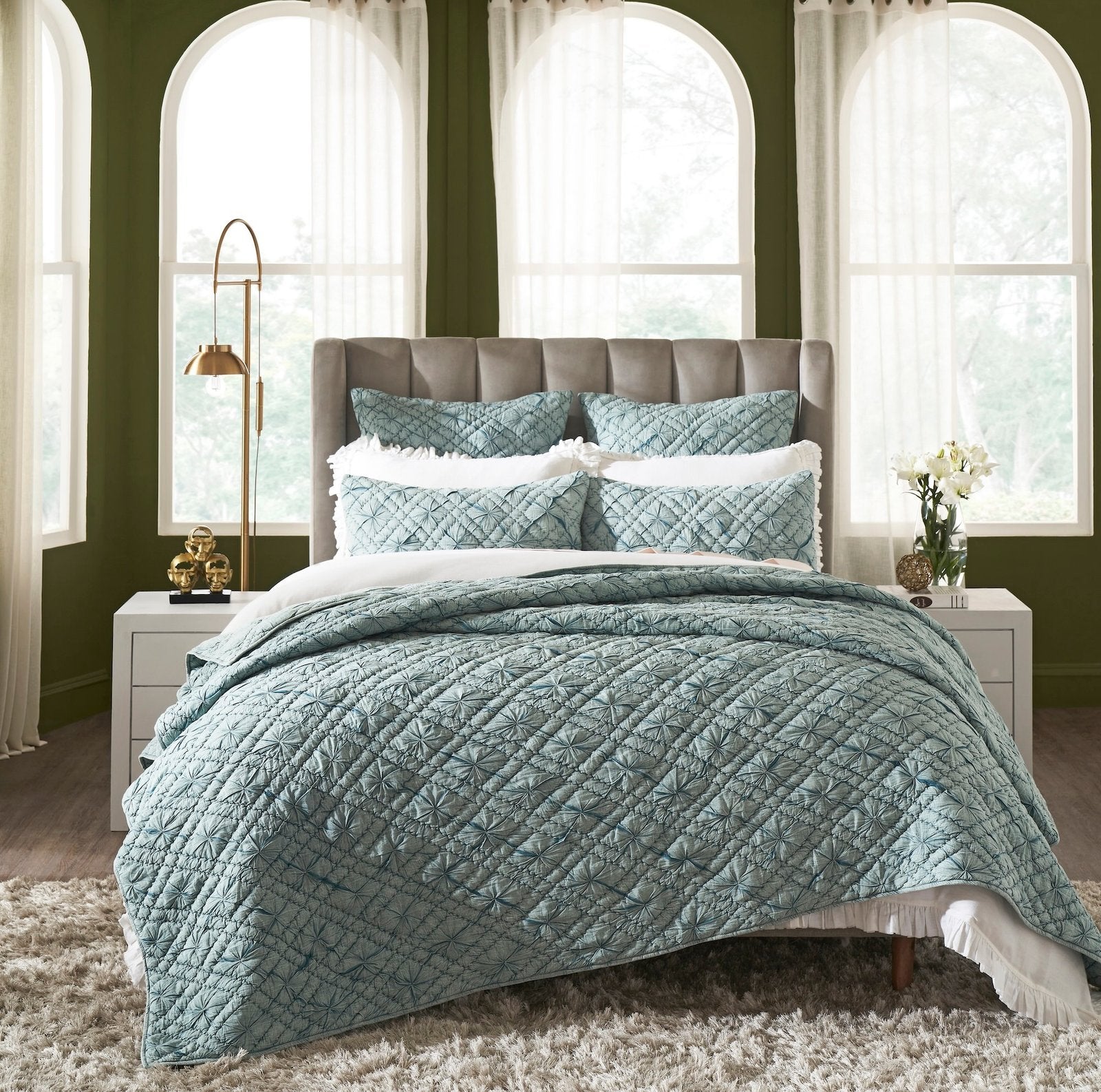 QT-365-11096_1|Elegant teal geometric quilted quilt on a bed with ruffled white sheets, enhancing a vibrant, stylish bedroom.