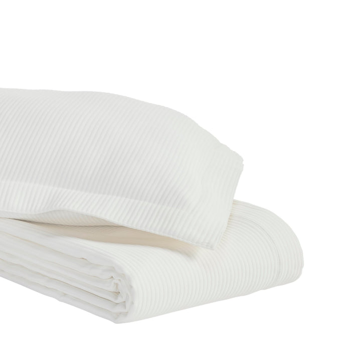 CL-192-11096_5|Neatly folded white striped coverlet and matching pillow, highlighting its crisp texture and quality fabric for bedding.