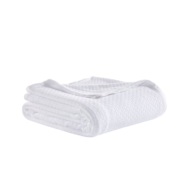 BL-851-11096_3|Neatly folded white waffle weave blanket, crisp and textured, providing comfort and a clean look for any room.