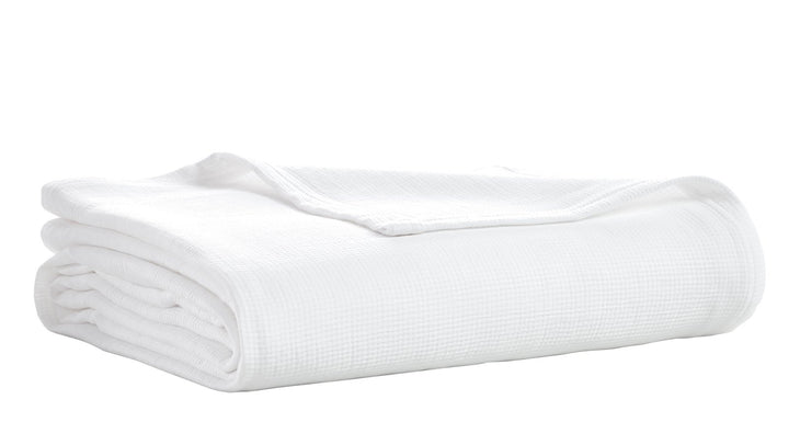 BL-858-11096_6|Neatly folded crisp white waffle weave blanket. Soft, breathable texture offers year-round comfort and elegant style.