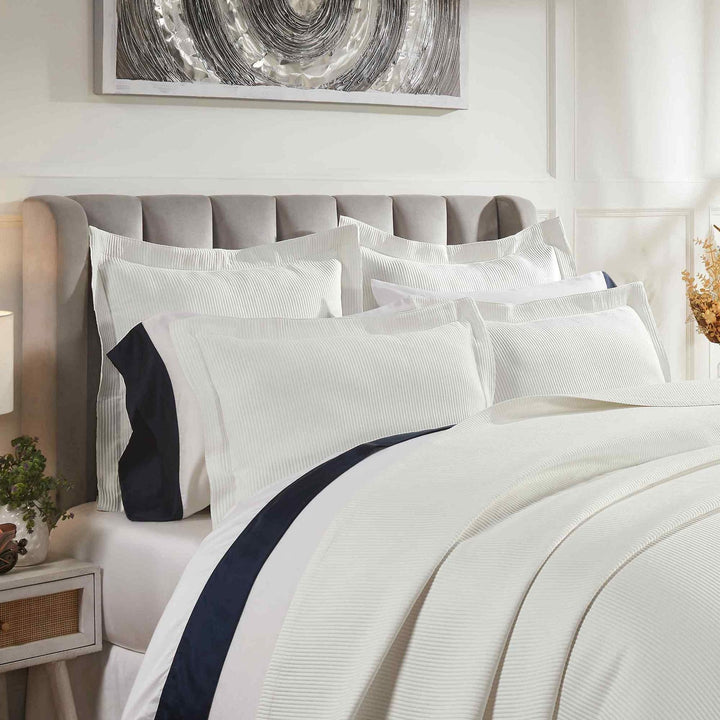 CL-192-9496_3|Detailed view of a crisp white striped coverlet and matching pillows, showcasing a luxurious and textured bedding ensemble.