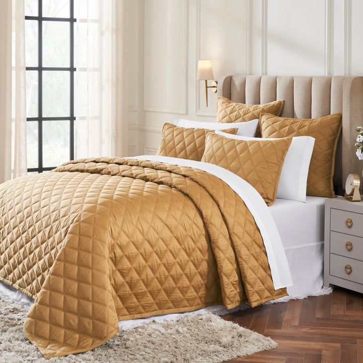 CL-260-11096_2|Luxurious gold diamond quilted coverlet elegantly draped over a bed, adding warmth and sophistication to decor.