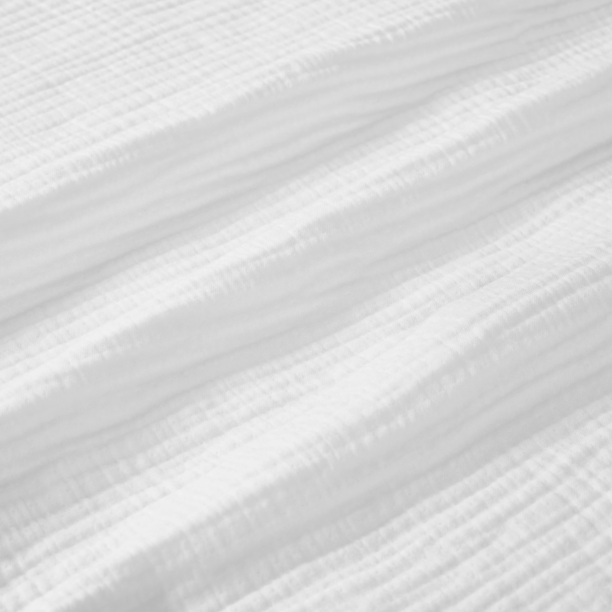BL-861-9496_8|Close-up of soft white crinkled muslin blanket fabric, highlighting its breathable texture for ultimate comfort.