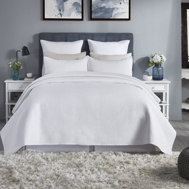 CL-200-9496_1|Crisp white textured coverlet beautifully drapes a queen bed, enhancing a serene, modern bedroom design.
